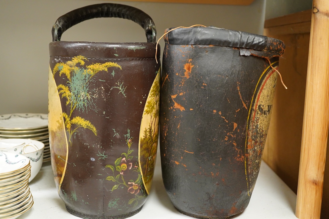 Two leather shot buckets, one with landscape cartouche, the other an advertising cartouche, 30cm high